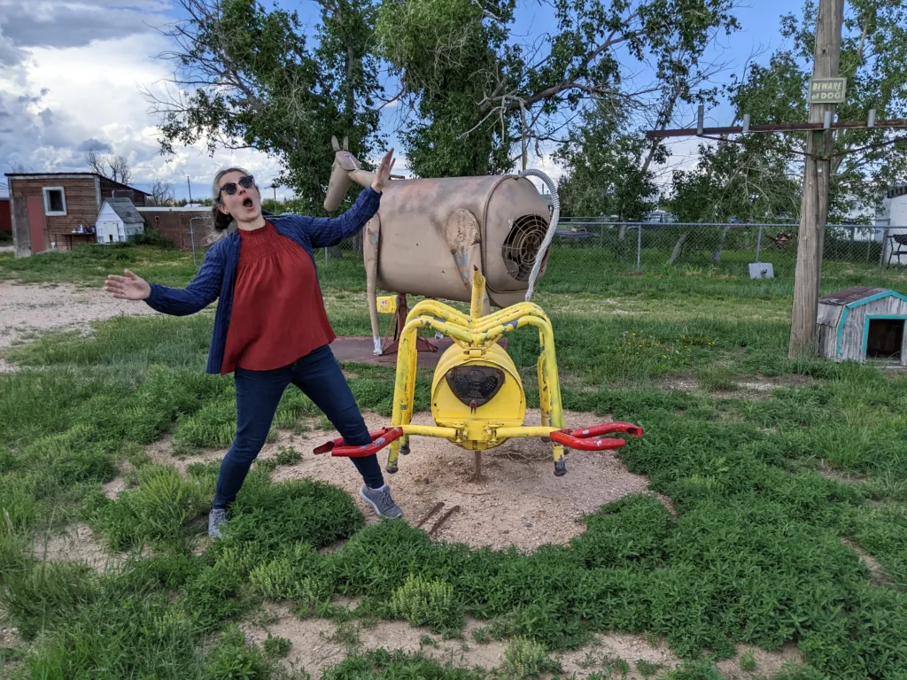 Samantha standing with a kinetic sculpture outside