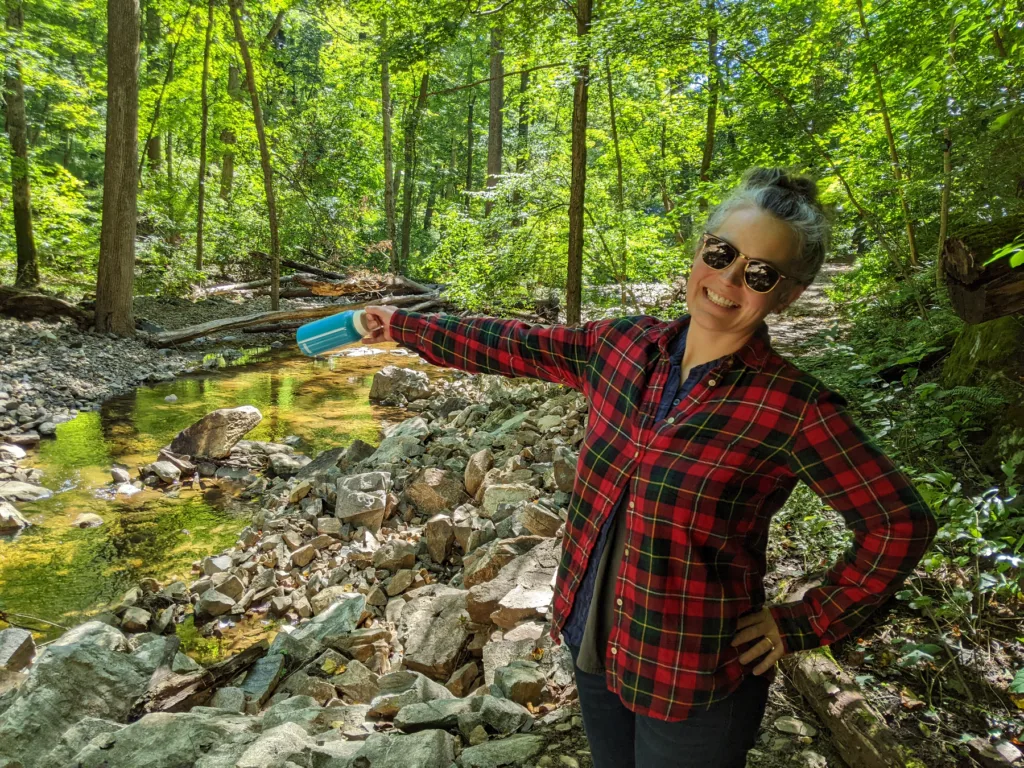 Samantha standing in the woods